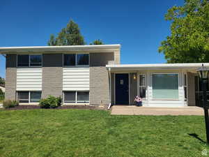 View of front of home featuring a front yard and a porch