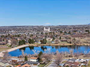 Aerial perspective of suburban area featuring a nearby body of water