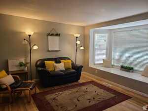 Living area with hardwood / wood-style floors