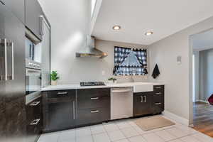 Kitchen with stainless steel appliances, light tile patterned floors, and modern cabinets