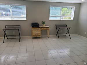Spare room with baseboards and light tile patterned floors