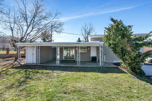 Back of property with a patio