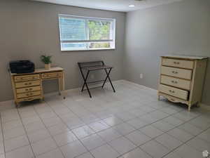 Bedroom with baseboards and light tile patterned floors