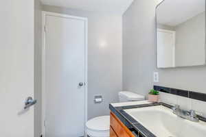 Half bathroom with toilet and vanity