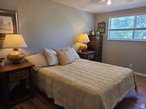 Bedroom featuring dark wood finished floors and a ceiling fan