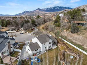 Aerial perspective of suburban area featuring a mountainous background