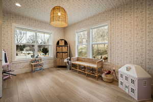 Living area with plenty of natural light and light wood-type flooring