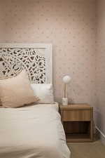 Bedroom featuring wallpapered walls and carpet