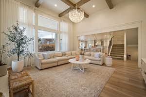 Living area featuring light wood-style floors and hanging lights