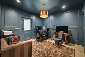Home office with a decorative wall and recessed lighting