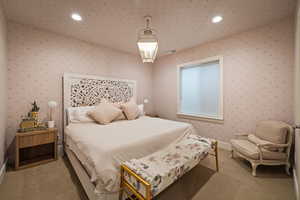 Carpeted bedroom featuring recessed lighting and wallpapered walls
