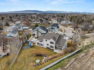 Aerial perspective of suburban area featuring a mountain backdrop