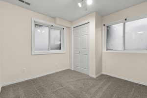 Unfurnished bedroom featuring a closet and carpet floors