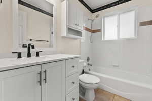 Bathroom featuring vanity, shower / washtub combination, and light tile patterned floors