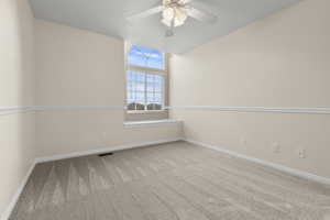 Empty room with light carpet and ceiling fan