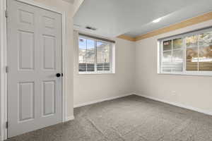 Spare room with light carpet and baseboards