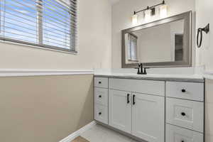 Bathroom featuring vanity and light tile patterned floors