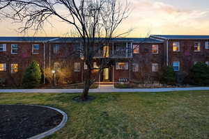 Property at dusk with a view of apartment building / complex
