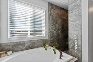 Ensuite bathroom with a garden tub, walk in shower and plenty of natural light