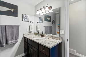 Bathroom featuring vanity and baseboards
