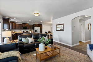 Living area featuring arched walkways and recessed lighting