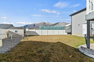 Fenced backyard featuring a mountain view