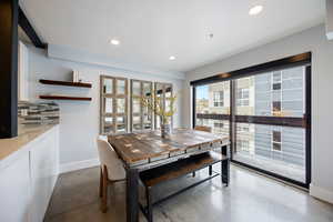 Dining area with finished concrete flooring and recessed lighting