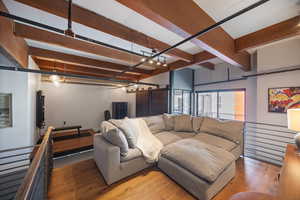 Living area featuring beamed ceiling and hardwood / wood-style flooring