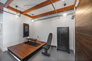 Office area with finished concrete flooring and baseboards, adjacent to second family room second level