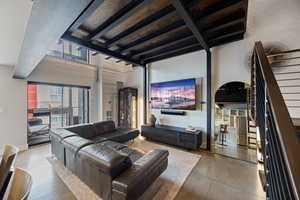Living area with concrete flooring and stairway
