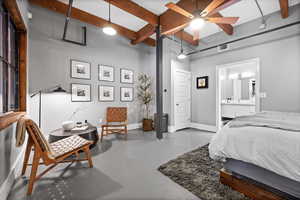 Bedroom featuring finished concrete floors and a ceiling fan