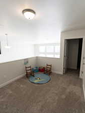 Playroom with dark carpet and baseboards