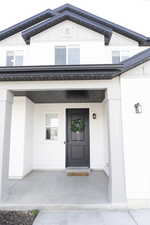 Doorway to property featuring a porch