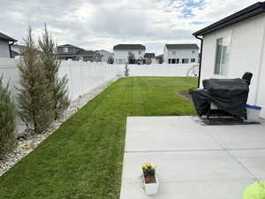 Fenced backyard featuring a patio area and a residential view