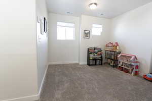 Game room with carpet and baseboards