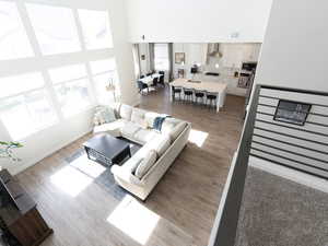 Living area featuring a high ceiling and light wood finished floors