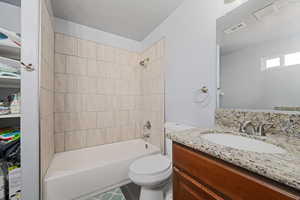 Bathroom with vanity, bathing tub / shower combination, and tile patterned floors
