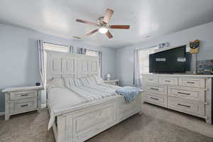 Bedroom featuring dark colored carpet and ceiling fan