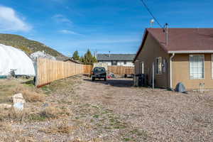 Fenced yard featuring a mountain view