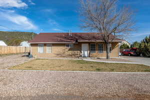 Ranch-style house with stucco siding and a porch