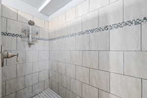 Full bath featuring tiled shower