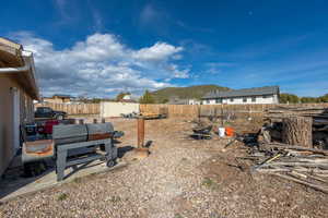 Fenced backyard with a patio area and a mountain view
