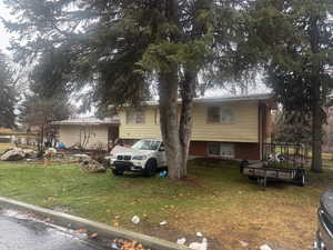 View of front of house featuring a front yard and brick siding