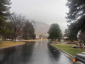 View of asphalt road with a mountain view and curbs