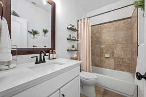 Bathroom featuring vanity and shower / tub combo with curtain