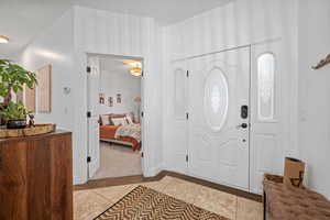 Foyer featuring light tile patterned floors