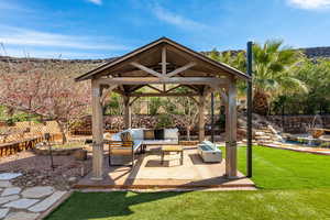 Fenced backyard with a patio and an outdoor lounge area