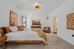 Bedroom with carpet and connected bathroom