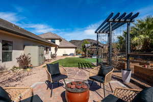 View of patio / terrace featuring a mountain view, a fire pit, and a pergola