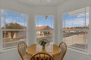 Dining area with a ceiling fan and plenty of natural light